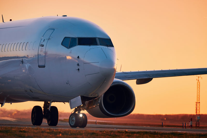 a plane on a runway about to take off during golden hour
