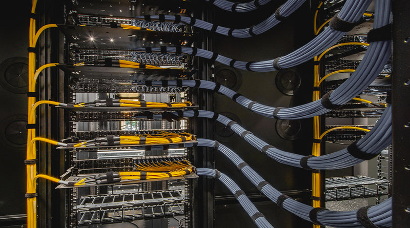 Server racks with cables in a data center setting