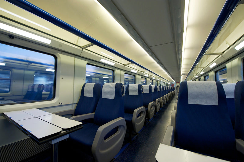 inside a train passenger cabin with blue seats