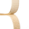 Close-up of a biege hook and loop fastener tape showing both hook and loop sides on a white background